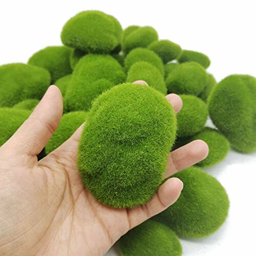 Hand holding artificial green moss stones.