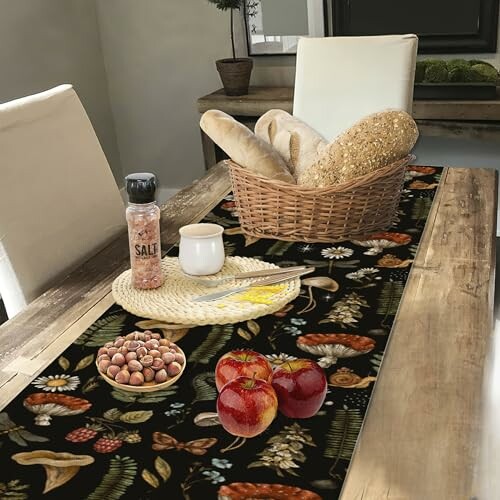 Table with bread, apples, nuts, and salt.