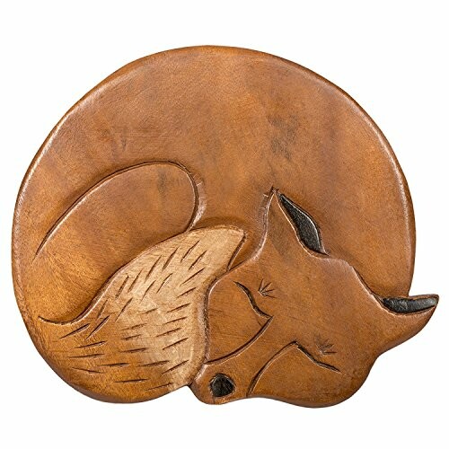 Carved wooden fox sleeping in a circular shape.