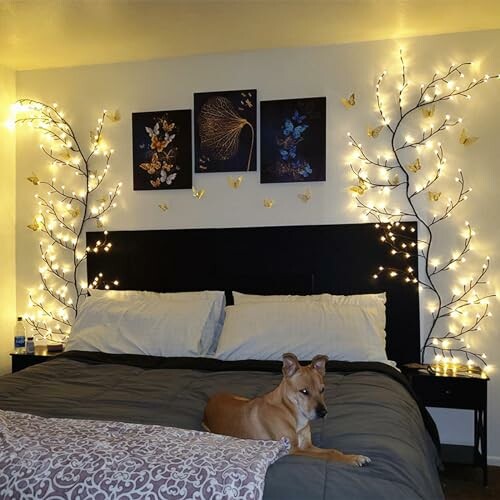 Cozy bedroom with a dog on the bed, surrounded by decorative lights and wall art.