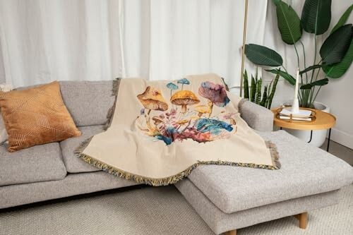 Sofa with a colorful mushroom-patterned blanket and a plant nearby