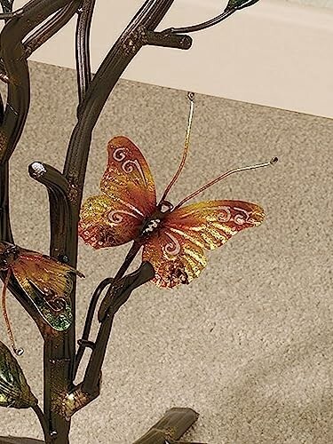 Metal butterfly decoration on tree sculpture.