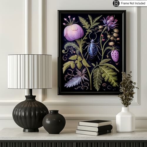 Elegant wall art with botanical illustration next to a lamp and books on a table