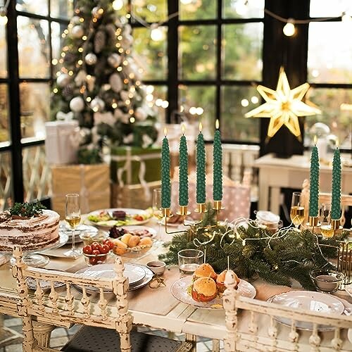 Festive Christmas table setting with candles, food, and decorations.