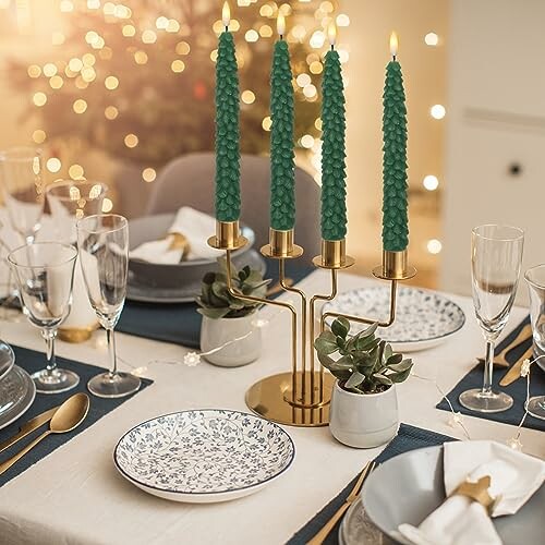 Festive dinner table with green candles and elegant tableware