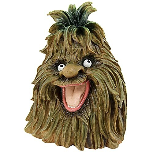 A humorous sculpture of a hairy monster with a big smile and wide eyes.