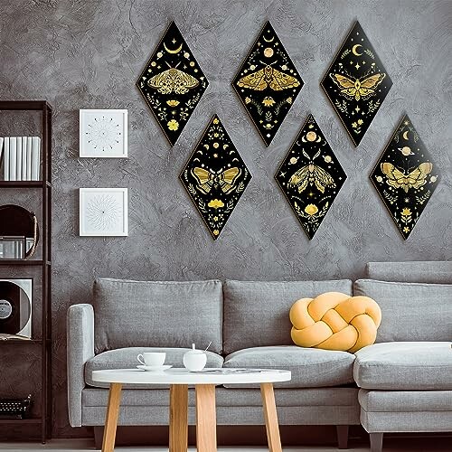 Geometric moth wall art above a gray sofa with a yellow cushion.