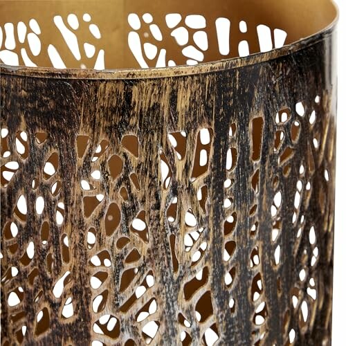 Close-up of a metallic lattice lamp shade with intricate cut-out design.