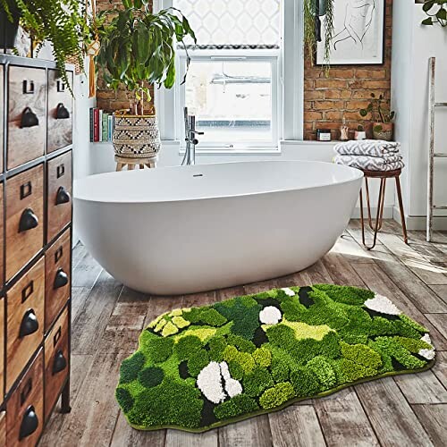 Modern bathroom with a white bathtub and a green patterned rug.