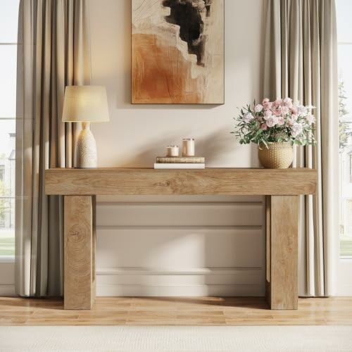 Modern wood console table with lamp and flowers.