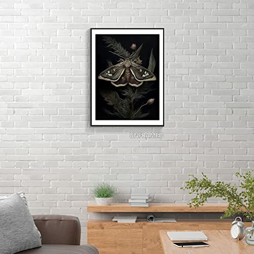 Framed moth artwork on a brick wall above a wooden shelf.