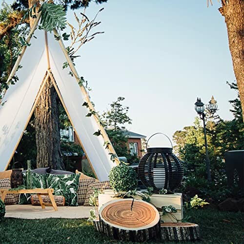 Outdoor tent with decorative greenery and wooden accents.