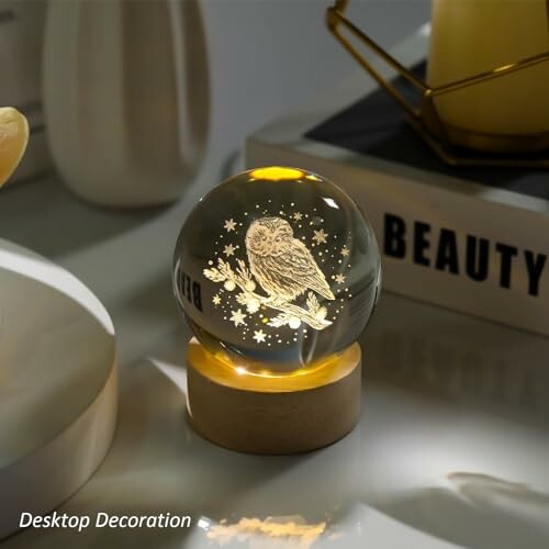 Glowing crystal ball lamp with owl design on a wooden base, used for desktop decoration.