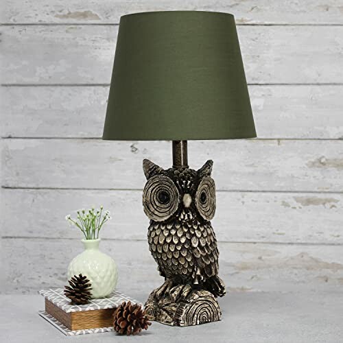 Owl-themed table lamp with green shade and decorative items