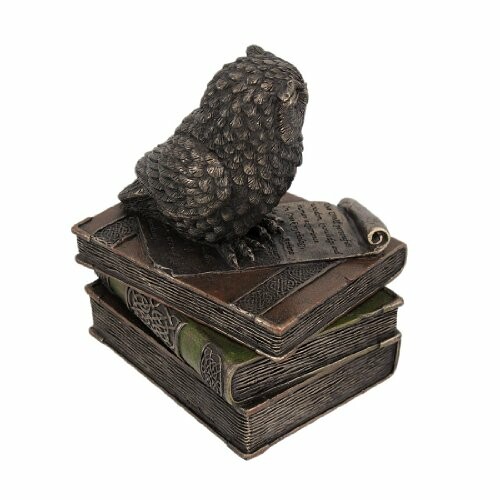 Bronze owl statue on stacked books