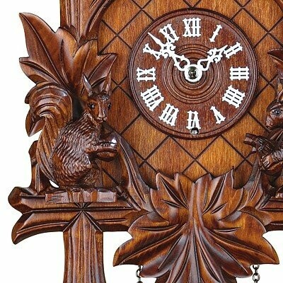 Detailed view of a wooden cuckoo clock with Roman numerals and carved squirrel